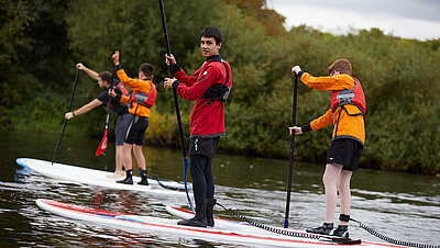 Pupil taking part in Stand-up paddle boarding